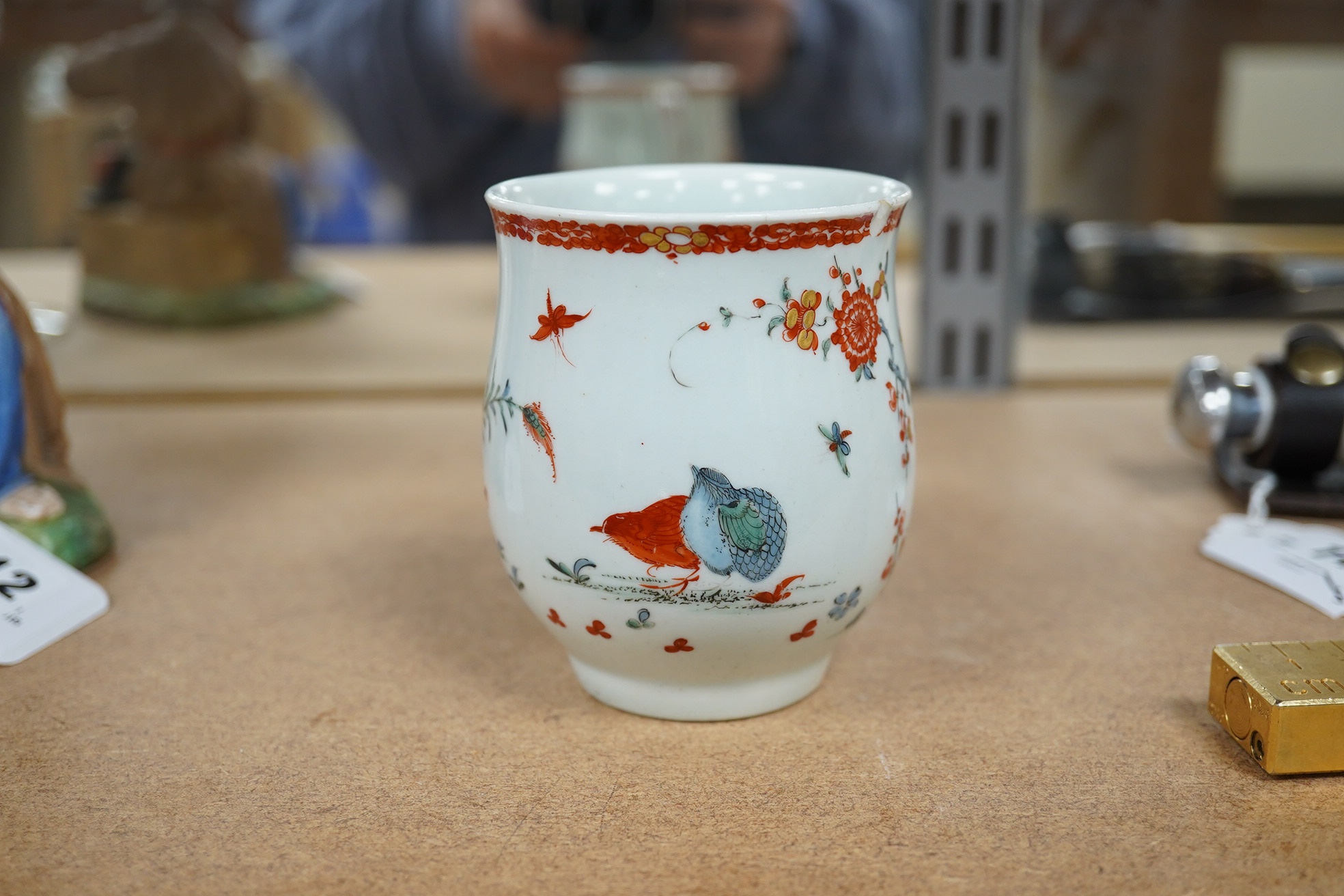 An 18th century Worcester polychrome porcelain mug decorated with quails, 9cm high. Condition - fair, chip to top rim